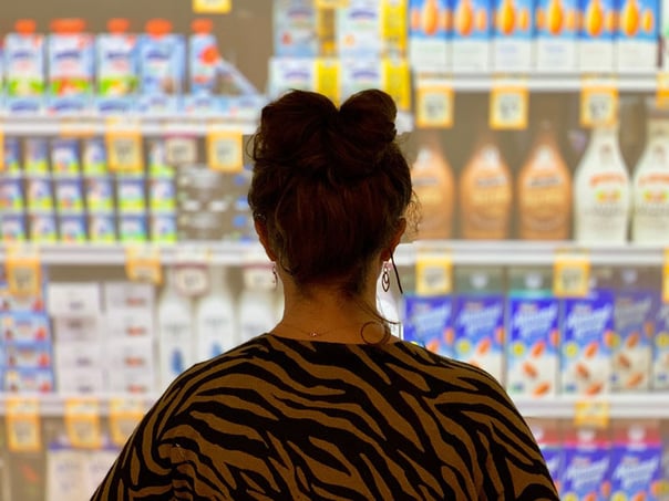 A women standing in front of supermarket shelves during an eye-tracking test