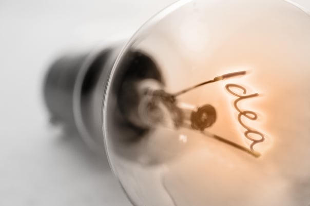 Close-up of a lightbulb filament shaped like the word ‘idea’