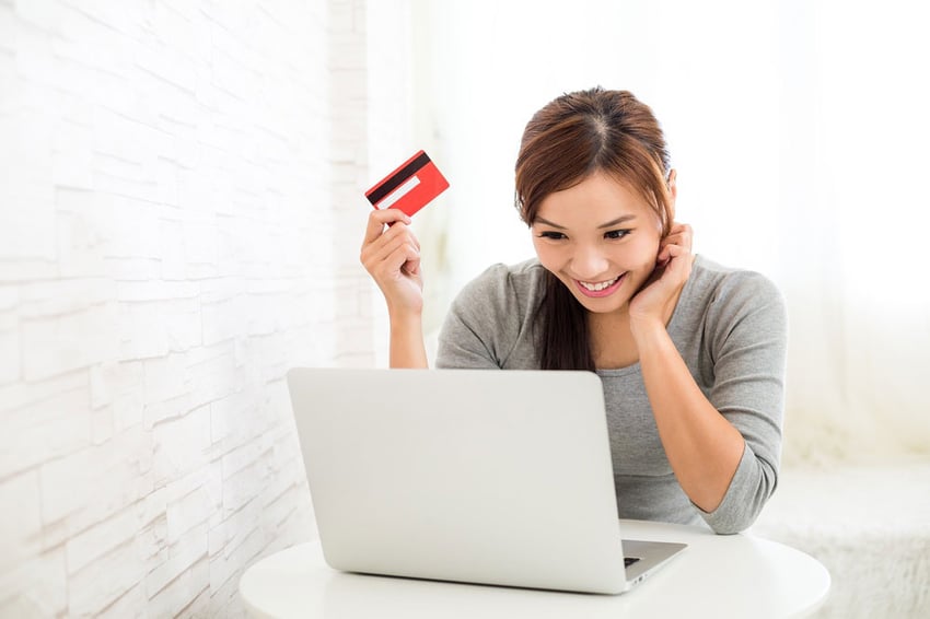 Woman-enjoy-online-shopping-paying-by-credit-card