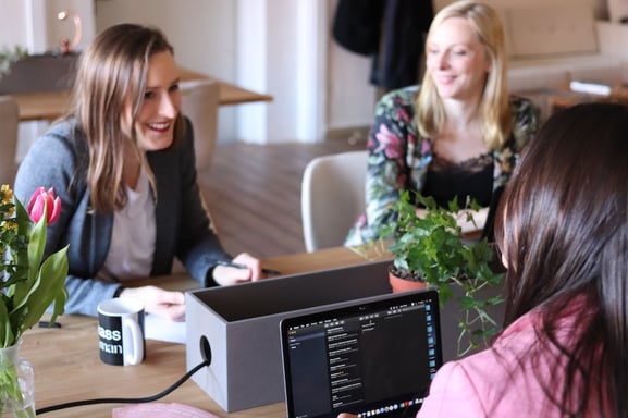 Three women seated, collaborating and planning a new product concept