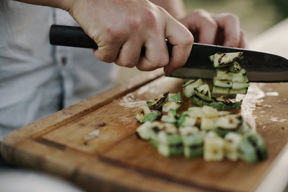 FMCG trends: person cuts up zucchini for scratch cooking.