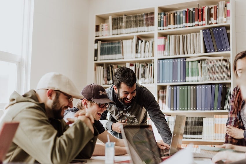 A product team in an office reviewing product performance data with their innovation partner.