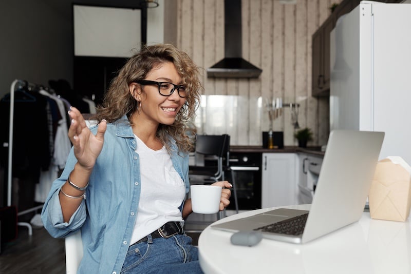 woman trying new drink over video research interview